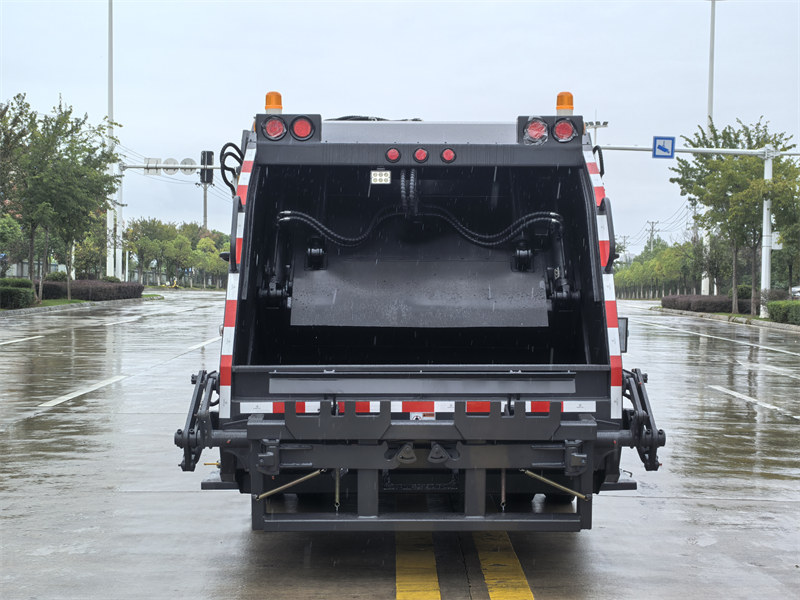 Rear view of refuse compactor truck